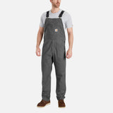 Salopette de travail Carhartt extensible en coton robuste, avec plusieurs poches et bretelles ajustables.