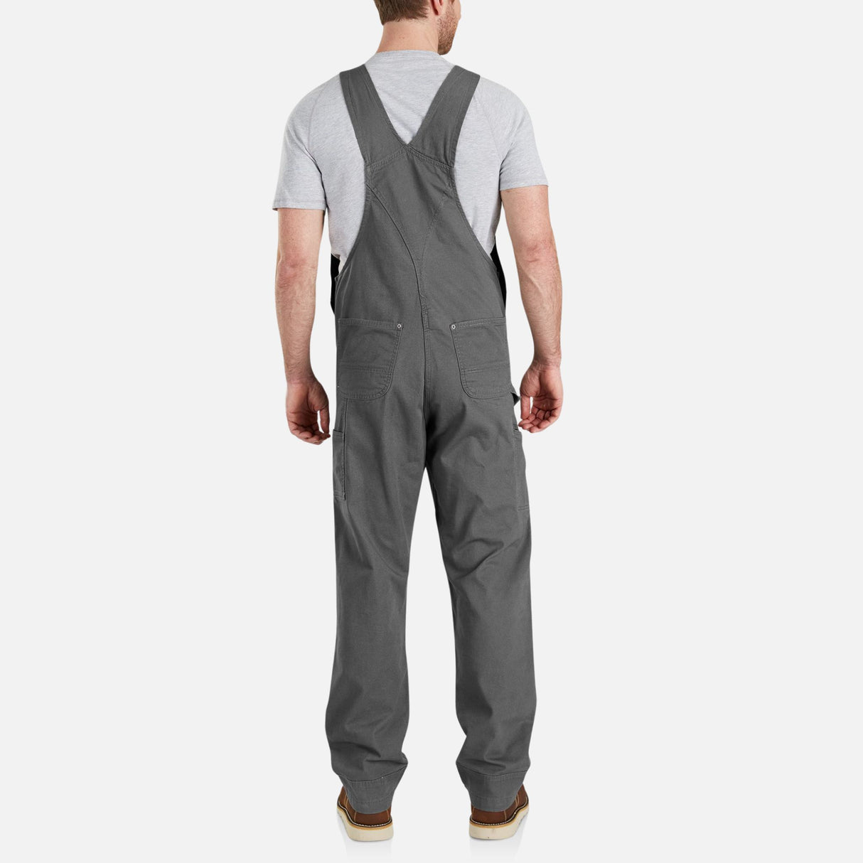 Salopette de travail extensible Carhartt, vêtement robuste avec zones de mouvement, en tissu résistant et pratique pour le travail.