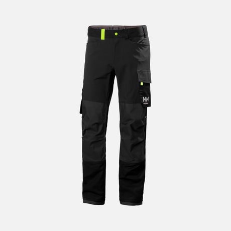 Pantalon cargo extensible Helly Hansen noir et vert, vêtement de travail léger et durable, avec plusieurs poches et design pratique.