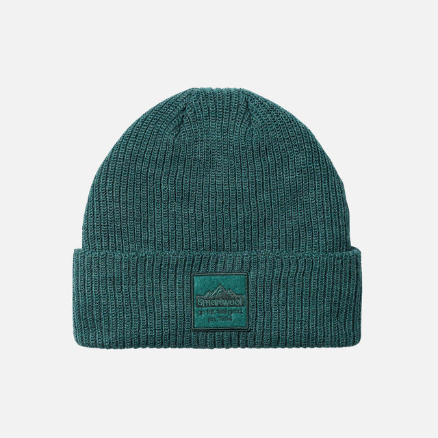 Tuque turquoise Smartwool avec écusson, accessoire chaud et confortable pour l'hiver, en laine naturelle.